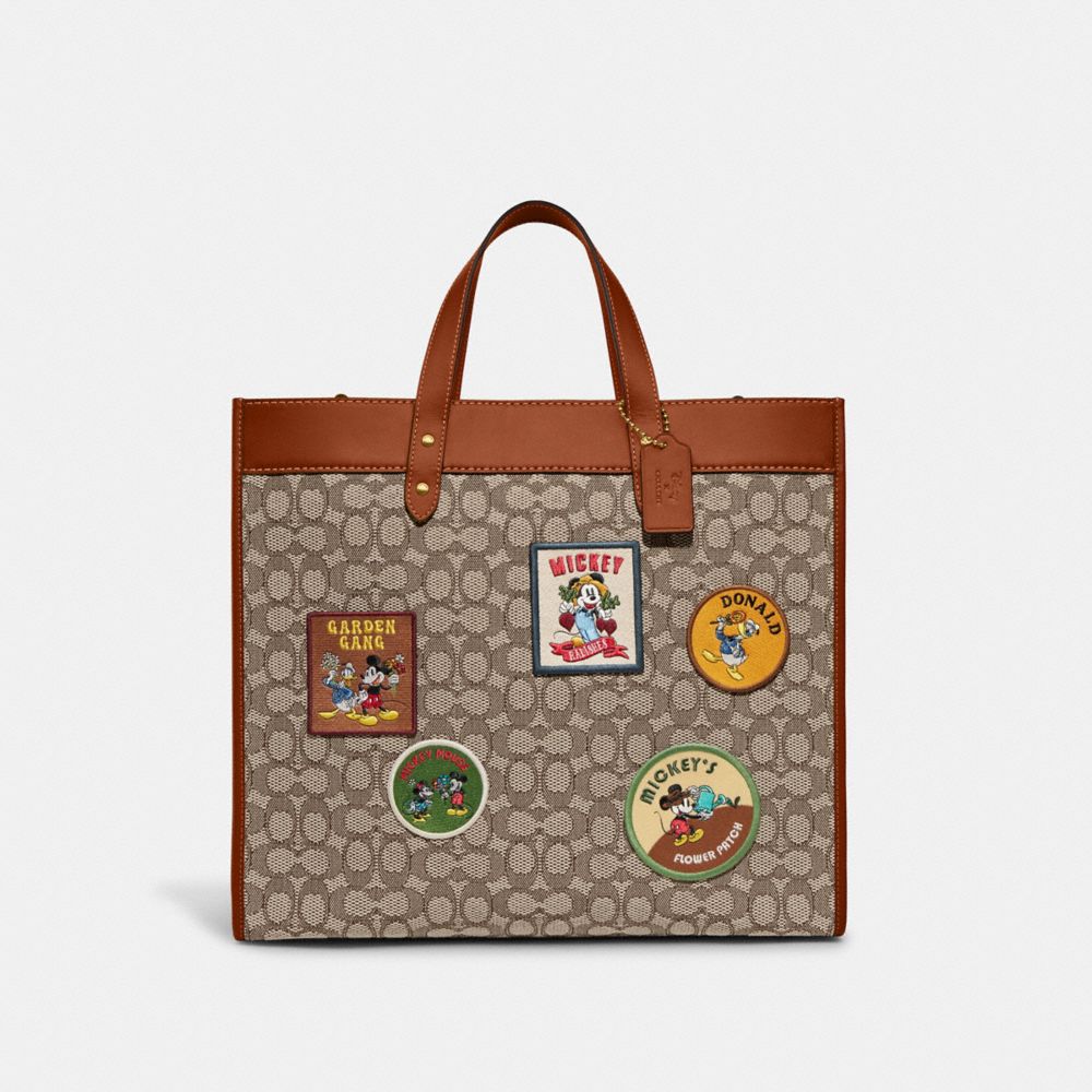 Coach Disney X Field Tote 40 aus charakteristischem Textil-Jacquard mit Patches